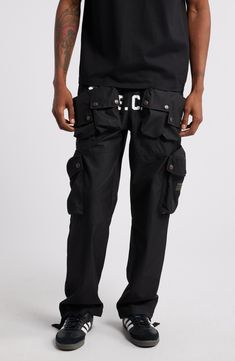 These cotton-blend cargo pants have an array of pockets and a slouchy silhouette for a streat-ready look. 30 1/2" inseam; 18" leg opening; 13" front rise; 16" back rise (size Medium) Elastic/drawstring waist Front snap-patch pockets; cargo snap-patch pockets; back decorative pocket flaps Lined 63% cotton, 37% nylon Hand wash, dry flat Imported Black Owned/Founded