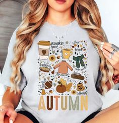 Autumn Doodles Tee (001) | Cozy Fall T-Shirts | Unique Gifts for Family Friends   Embrace the coziness of fall with our cute, groovy, and retro t-shirts. Welcome the crisp air and vibrant hues of fall with our exclusive Autumn tees! Designed to capture the season's spirit perfectly, these tees are a must-have for your autumn wardrobe. Made from premium, breathable cotton, our t-shirts ensure maximum comfort for those cool fall days and cozy bonfire nights.   Key Features: High-Quality Material: Autumn Doodles, Autumn Wardrobe, Bonfire Night, Crisp Air, Fall Days, Fall Tee, Fall Sweatshirt, Retro Tshirt, Cozy Fall