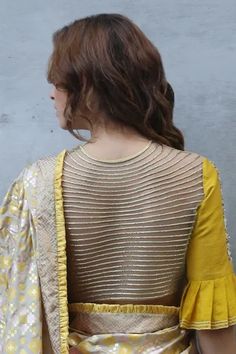 Mustard padded crop top with floral dori and kantha placement embroidery, elbow length sleeves with flared pleated hems and sheer back.
Component: 1
Pattern: Embroidery
Type Of Work: Floral and Kantha Embroidery
Neckline: Round
Sleeve Type: Flared Sleeves
Fabric: Raw Silk
Color: Yellow
Other Details: 
Sheer back with embroidery
Sleeves with flared pleated hems
Closure: Button front
Note: Saree worn by the model is not for sale
Occasion: Mehendi and Haldi - Aza Fashions Padded Crop Top, Placement Embroidery, Embroidery Neckline, Crop Top For Women, Kantha Embroidery, Crop Tops Online, Embroidered Crop Tops, Pattern Embroidery, Top For Women