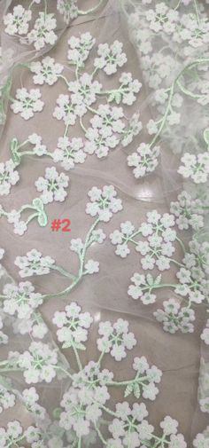 We offer a variety of fashion handmade fabric，those are widely use for wedding dress，garment and fashion cloth. we sell it by yard，our minimum order is 1 yards，and we always package it 15 yards for one roll，the width is 130cm Material ： mesh ，Rayon,polyester. Symmetrical embroidery floral pattern, with lovely flowers in the middle, scalloped border. You can also cut and use separately. Perfect for dress, tops, wedding veil. You can split the piece up and have one scalloped edge around the veil a Elegant Embroidered Lace Fabric For Spring, Elegant Lace Embroidered Fabric For Spring, Spring Fitted Floral Embroidery Lace, Summer Lace Dress With Appliques, Spring Party Crochet Lace, Elegant Spring Embroidered Fabric With Floral Applique, Spring Lace Patchwork Tulle Fabric, White Floral Embroidery Lace For Summer Weddings, White Floral Embroidered Lace For Summer Wedding