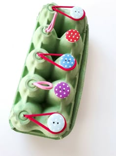 an egg carton filled with lots of buttons