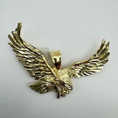 Beautiful Design Accessory crafted in 14k Solid Gold Eagle Pendant - 14k Solid Yellow Gold - ME13 Condition: Excellent pre-owned. Shows minimal signs of wear as pictured (these are very close-up photos). Metal Content: Guaranteed 14k solid Gold as Stamped Pendant's Length: 2 in Pendant's Width: 2.50 in Pendant's Thickness: 2.66 mm Total Weight: 8.6 gr Actual item pictured. All of our pictures are authentic to show you every angle of the item. Thank you for shopping at our vintage store. Most of the items we sell are one-of-a-kind so please enjoy scrolling through our shop and we are here to answer any questions you have. If you are not 100% satisfied with the item, you get your money back! Please return/ship the item back within 30 days or less for a full refund. Thank You! You can still h Collectible 14k Gold Jewelry With Polished Finish, Gold-tone 14k Gold Jewelry For Anniversary, 14k Gold-tone Jewelry For Anniversary, 14k Gold Jewelry With Vvs Clarity, Eagle Pendant, Gold Eagle, Close Up Photos, Vintage Store, Solid Yellow