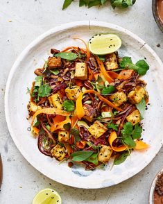 a white plate topped with vegetables and tofu