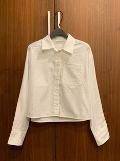 Cropped style collared shirt with three-dimensional stripe pattern. Rich volume yet loose overfit style. Model is in MINUSEY ONE SIZE. ✔️ Free worldwide express shipping over $100✔️ Loved by 6,500+ customers✔️ Limited edition collections, maximum style⠀⠀⠀⠀⠀⠀⠀⠀⠀Stay ahead of the trend with can’t-find-anywhere-else staples. Your closet will thank you 💕* MINUSEY ONE SIZE = EU 34-38, US 2-6* 100% Cotton* Dry clean* Made in Korea - Model Height: 172cm/5'7" (US2, EU34) White Oversized Top With Lapel Collar, Oversized White Top With Lapel Collar, White Top With Striped Spread Collar, Oversized White Shirt With Striped Collar, Chic White Shirt With Striped Collar, White Long Sleeve Blouse With Striped Collar, White Top With Striped Collar, White Top With Striped Collar For Workwear, White Shirt With Striped Collar For Work