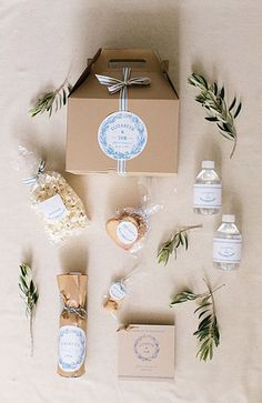 an open box with soap, lotion and other items laid out on a bed