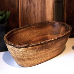 a wooden bowl sitting on top of a table