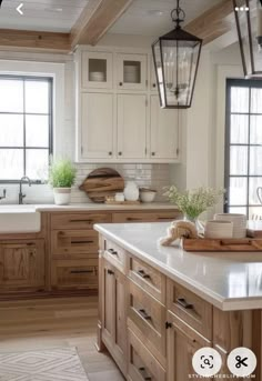 a kitchen filled with lots of wooden cabinets and white counter tops next to a window