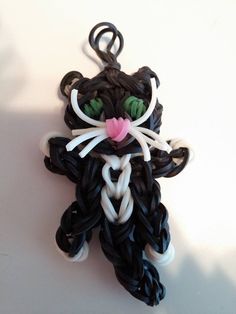 an ornament made to look like a cat with green eyes and pink nose