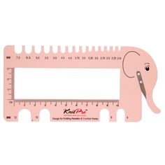 a pink ruler with an elephant drawn on it's face and measuring tape in front of it