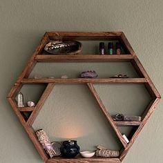 a wooden shelf with various items on it and a light in the corner behind it