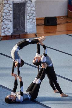 two young women doing acrobatic tricks on the floor