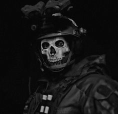 a man wearing a helmet and skeleton makeup in the dark with his hands on his hips