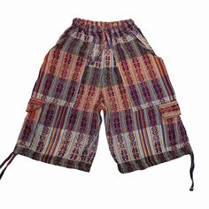 "Handcrafted for comfort and style, our cargo shorts blend the best of boho vibes with practicality. Whether you're gearing up for Burning Man, a music festival, or just a casual day out, these handmade shorts are the ultimate summer essential. With a high waist design and ample pockets, they cater to both men and women, ensuring you're ready for any adventure. Elevate your streetwear game with these versatile, baggy shorts, perfect for rocking your inner hippie or rave-ready ensemble. Embrace the freedom of movement and storage with our cargo shorts - the ultimate fusion of fashion and function! This pair of shorts was handmade by Ecuadorian artisans using the foot-treadle loom technique. It has a drawstring in the waist and the pant legs have tying drawstring hems.  Materials: 75% cotton Summer Cotton Cargo Shorts With Pockets, Cotton Summer Cargo Shorts With Pockets, Cotton Summer Cargo Shorts, Cotton Cargo Shorts With Pockets For Vacation, Multicolor Hippie Shorts For Vacation, Casual Festival Shorts, Short Bottoms With Cargo Pockets For Vacation, Vacation Cargo Bottoms Short Length, Vacation Shorts With Cargo Pockets