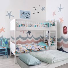 a child's bedroom with two bunk beds and starfish wallpaper