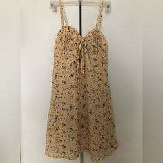 Never Worn, Perfect Condition, New With Tag Pastel Yellow With Blue And White Flower Detailing Pockets Inside Liner, Not See Through Expandable Back; Fitted At Waist With Flowy Skirt Adjustable Straps Knee-length Floral Print Sundress For Day Out, Floral Print Knee-length Sundress, Floral Print Knee-length Sundress For Brunch, Knee-length Ditsy Floral Mini Dress For Beach, Knee-length Floral Print Sundress For Brunch, Knee-length Mini Dress With Ditsy Floral Print For Vacation, Summer Knee-length Mini Dress With Ditsy Floral Print, Casual Ditsy Floral Print Dress With Spaghetti Straps, Knee-length Ditsy Floral Print Beach Dress