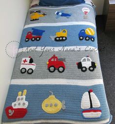 a crocheted blanket with cars and trucks on it