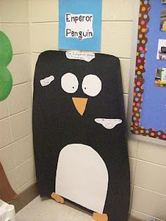 a black and white penguin sitting on top of a toilet in a bathroom next to a tree