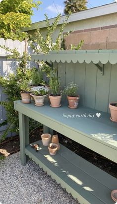 several potted plants are sitting on a bench