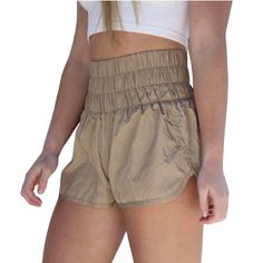 these free people running shorts are light and breezy. they feature a surprisingly comfortable high-rise smocked waistband that can easily be folded down and a side split hem for added style. also available in army green, varsity gold, optic white, deep sea, moonlight mauve, artic mist, black and trance print. details 100% nylon machine wash cold size + fit model is 5'7 wearing a size small Khaki Beach Shorts With Elastic Waistband, Khaki Shorts With Built-in Shorts For Vacation, Casual Beige Athletic Shorts For Summer, Lightweight Stretch Summer Shorts, Lightweight Stretch Shorts For Summer, Summer Athleisure Beige Shorts, Beige Athletic Shorts With Built-in Shorts For Summer, Beige Athleisure Shorts For Summer, Summer Lightweight Athletic Shorts With Relaxed Fit