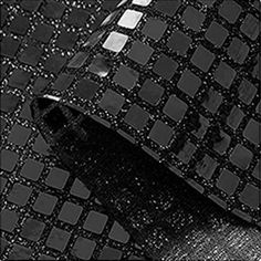 a black and white photo of a tie with squares on the pattern, as if it were made out of fabric