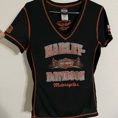 a harley davidson shirt hanging on a wall