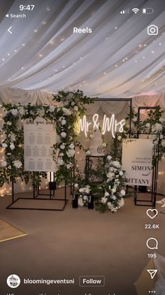 an image of a wedding setup with flowers on the wall and menus for the ceremony