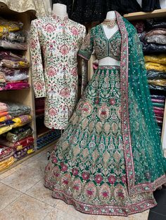 two mannequins are standing next to each other in front of clothing racks