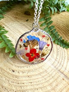 Handmade Epoxy resin necklace with real dried flowers. Made in the UK. Perfect and unusual gift idea. Comes beautifully presented in a gift box. Pendant material - alloy, hypoallergenic. Chain material:  sterling silver, silver plated, lightweight.  Stay close to nature with this necklace. Perfect happy summer necklace with bright colours flowers. Perfect anniversary, birthday or leaving gift.  Forget-me-nots symbolize true love and respect. When you give someone these tiny blooms, it represents Pressed Flowers Flower Pendant Necklace For Birthday, Pressed Flowers Necklace For Mother's Day Keepsake, Unique Pressed Flowers Jewelry Gift, Unique Pressed Flowers Jewelry For Gift, Unique Pressed Flowers Jewelry As Gift, Flower Pendant Necklace With Pressed Flowers For Birthday, Birthday Gift Flower Pendant Necklace With Pressed Flowers, Botanical Birth Flower Necklace Gift, Mother's Day Keepsake Necklace With Pressed Flowers