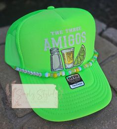 Who doesn't like a good margarita on a hot summer day?  If you prefer a different hat color or hat chain just message me.  I will be making different styles and colors of this hat style very soon!  Join my VIP Facebook group:  https://m.facebook.com/groups/647373030278085/?ref=share&mibextid=NSMWBT Website: shopsimply-styled.com Fun Snapback Hat With Short Brim For Beach, Adjustable Flat Brim Trucker Hat For Summer, Summer Festival Snapback Cap, Summer Festival Snapback Hat, Trendy Adjustable Snapback Hat For Summer, Fun Adjustable Brimmed Trucker Hat, Fun Short Brim Trucker Hat For Beach, Fun Short Brim Trucker Hat For The Beach, Green Summer Trucker Hat With Flat Brim