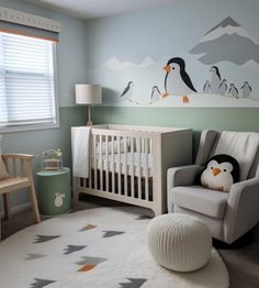 a baby's room decorated in gray and white with penguins painted on the wall