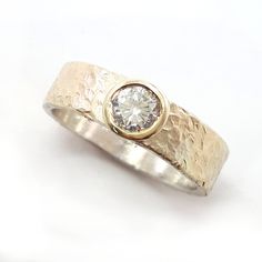 A classic semi-wide sterling silver band overlaid with a hammered yellow gold sheet (0.15 mm), set with a CZ (cubic zirconia) gemstone. The gold is soldered to the silver band, not plated. The gold won't flake or wear off - guaranteed. Measurements: Width: 0.24 inch / 6 mm CZ width: 0.2 inch / 5 mm Sizes: This listing is for sizes 4-13. If a different size is needed, please contact us. Additional information If you liked this item, you may also want to look at these pieces: http://etsy.me/2fOtGA Wide Gold Band, Space Rings, Gold Sheets, Mixed Metal Rings, Space Jewelry, Real Jewelry, Sterling Silver Engagement Rings, Ring Ideas, Alternative Engagement Rings