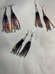 Native American Inspired Fringe Earrings with Feathers - My Community Made Multicolor Long Drop Fringe Earrings, Multicolor Long Drop Tassel Earrings With Dangling Beads, Multicolor Long Drop Earrings With Beaded Fringe, Long Drop Beaded Tassel Earrings For Festival, Artisan Beaded Dangle Tassel Earrings, Multicolor Long Drop Beaded Earrings With Fringe, Artisan Multicolor Beaded Tassel Earrings, Multicolor Fringe Beaded Earrings As Gift, Multicolor Beaded Fringe Earrings With Unique Style