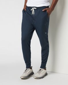 A fresh take on athleisure and a staple in your wardrobe, the Sunday Performance Joggers are premier in fit, function and soft stretch. This jogger style will keep you moving with less bulk around your ankles. | Vuori Sunday Performance Jogger Pants | Ink Heather | Medium Vuori makes premium performance apparel inspired by the active Coastal California lifestyle; an integration of fitness, surf, sport, and art. Breaking down the boundaries of traditional activewear, we are a new perspective on p 4-way Stretch Sportswear Joggers With Side Pockets, Athleisure Joggers With Comfort Stretch And Pockets, Athleisure Joggers With Ribbed Waistband And Stretch, Functional Moisture-wicking Comfort Stretch Sweatpants, Sportswear 4-way Stretch Joggers With Side Pockets, Athleisure Activewear With Functional Drawstring For Jogging, Athleisure Activewear For Jogging With Drawstring, Athleisure Joggers With Pockets, 4-way Stretch Sweatpants With Pockets For Jogging