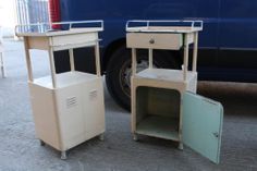 two old metal cabinets sitting next to a blue van