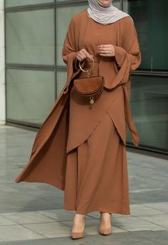 Introducing the Deluna three piece maxi lightweight abaya in rustic brown. This elegant and versatile design is perfect for any season and includes a long sleeve slip dress, apron piece, and a throw over abaya. The fabric is specially designed to resist wrinkles and the contrast brown color overlook seam at the edge of the abaya stands out.The abaya is super lightweight and flowy making it perfect for hot weather. The apron piece allows you to adjust the fit and the pattern of the abaya is not o Modest Maxi Length Abaya For Fall, Fall Season Modest Maxi Length Abaya, Fall Modest Maxi Length Abaya, Modest Long Abaya For Fall, Elegant Floor-length Fall Abaya, Modest Solid Color Floor-length Abaya, Modest Floor-length Abaya, Fall Solid Color Maxi Length Abaya, Brown Long Dress For Eid