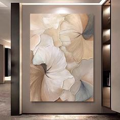 an abstract painting with white flowers on the wall in a modern living room, it appears to be framed or unframeed