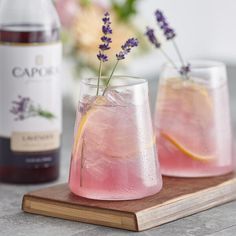 two glasses filled with pink lemonade and lavender sprigs