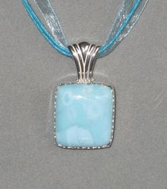 "This is an absolutely beautiful piece of Larimar. Stunning! This material only comes from the Dominican Republic. The stone is a clean, blue. Really nice and it's a good size chunk, as well. This stone is all natural. Cut and polished to a beautiful shine. I set it in sterling silver, created just for this stone. It has a large bail to fit most chains or cord necklaces. You can't go wrong with this one. It might work for unisex too. The face of the stone is approx. 7/8\" x 7/8\" square. A real beauty. This one could be your signature piece. It's a beautiful statement. Thank you for looking at a pendant from Jewelry By Sala, handmade and polished by me, in my Northern California workshop. This pretty pendant will ship Free, with insurance for the continental US only. I am happy to ship int Handmade Larimar Round Necklace, Handmade Silver Larimar Necklace, Elegant Larimar Pendant Jewelry, Cord Necklaces, Blue Larimar Pendant Necklace, Larimar Pendant, Pretty Pendant, The Dominican Republic, Real Beauty