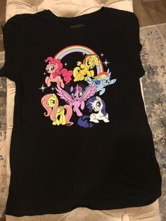 My Little Pony Shirt Shipping from the US. Easy 30 day return policy, 100% cotton, Double-needle neck, sleeves and hem; Roomy Unisex Fit. Casual Multicolor Character Print Shirt, Casual Short Sleeve Shirt With Character Print, Casual Multicolor Character Print Tops, Multicolor Relaxed Fit Shirt With Character Print, Fun Relaxed Fit Shirt With Character Print, Trendy Relaxed Fit Shirt With Character Print, Graphic Tee With Character Print In Multicolor, Multicolor Character Print Graphic Tee, Relaxed Fit Graphic Tee With Character Print