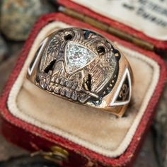 This great vintage mens 32° Masons ring features a diamond at the center of a white gold double eagle. The shoulders and shank of the ring are decorated with enameled masonic symbols. It is crafted in a patinated 10k yellow gold and is a size 8.5. We are not offering resizing due to the enameling. A small amount of enamel shows wear. Classic Engraved Enamel Ring For Formal Occasions, Formal Symbolic Diamond Ring, Diamond Rings Symbolic For Formal Occasions, Symbolic Diamond Ring For Formal Occasions, Formal Engraved Enamel Signet Ring, Double Eagle, Masonic Symbols, Masonic Ring, Mens Vintage