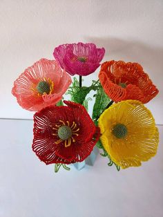 a vase filled with colorful flowers on top of a table