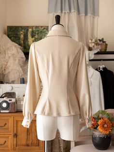 Add a touch of Victorian elegance to your wardrobe with this beige long-sleeve shirt featuring a detachable jabot on the neckline. Perfect for adding a sophisticated and gothic twist to your outfit, this versatile piece can be dressed up or down for any occasion.  This price includes a shirt and a detachable jabot.   	 		 			Size 			S 			M 			L 			XL 			2XL 		 		 			Shoulders 			38 			39.5 			41 			42.5 			44 		 		 			Bust 			86 			92 			98 			104 			110 		 		 			Waist 			68 			74 			80 			86 			92 		 		 			Sleeve Length 			59 			60 			61 			62 			63 		 		 			Bicep 			36 			38 			40 			41 			42 		 		 			Full Length 			58 			59 			60 			61 			62 Fitted Beige Long Sleeve Blouse, Beige Fitted Long Sleeve Blouse, Elegant Fitted Blouse With Lapel Collar, Elegant Long Sleeve Cream Tops, Elegant Cream Long Sleeve Tops, Elegant Long Sleeve Blouse With Detachable Collar, Elegant Fall Tops With Detachable Collar, Elegant Tops With Detachable Collar For Workwear, Chic Fitted Top With Detachable Collar