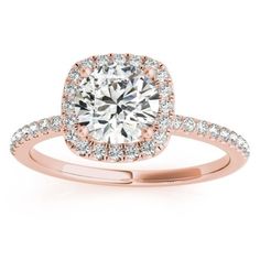 a rose gold engagement ring with an oval halo setting and pave set diamonds on the band