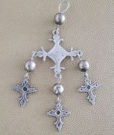 Beautiful large rustic Yalalag cross from the 50's acquired in Oaxaca. Cross is unmarked, but has tested as silver. Beads are base metal or copper with a silver wash. The minor markings or imperfections on the silver crosses only add to their amazing patina. Pendant alone is 4 1/2" long. With its looped bail and bead, it is 5 3/4" long.  It's main cross is 2 1/4" wide. With the inclusion of the smaller crosses, it is in total approximately 3" " wide. A truly amazing piece and clearly well-loved Vintage Sterling Silver Cross Necklace, Vintage Silver Sterling Silver Cross Necklace, Traditional Silver Cross Necklace, Spiritual Silver Cross Necklace With Oxidized Finish, Bohemian Metal Cross Jewelry, Bohemian Cross Metal Jewelry, Vintage Silver Cross Pendant Jewelry, Silver Beaded Cross Jewelry, Artisan Silver Crucifix Jewelry