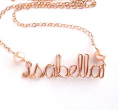 Personalize this 14k rose gold filled necklace with any name or word up to 10 letters long. This hand wire wrapped custom designed name is made in all lowercase letters in cursive script from 14k rose gold filled wire and chain with 2 rich pink freshwater pearls added on either side. The width of the name portion generally measures 3/4 inch to 2 inches wide, and the length you select will include the name and chain. Your necklace will arrive beautifully wrapped, ready for gift giving. The model Adjustable Rose Gold Name Necklace With Custom Name, Delicate Rose Gold Name Necklace, Custom Name Rose Gold Necklace, Handmade Rose Gold Name Necklace As Personalized Gift, Handmade Rose Gold Name Necklace For Personalized Gift, Handmade Rose Gold Name Necklace For Mother's Day, Letters In Cursive, 16 Inch Necklace, Pink Pearls