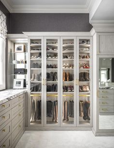 a walk in closet filled with lots of shoes