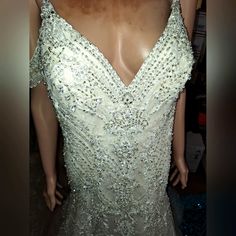 a mannequin wearing a white dress with sequins on it