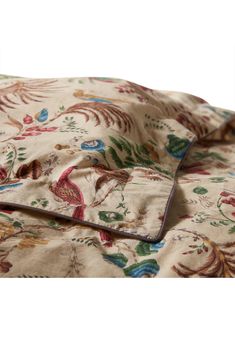 the comforter is made up with an intricate floral pattern and matching pillowcases