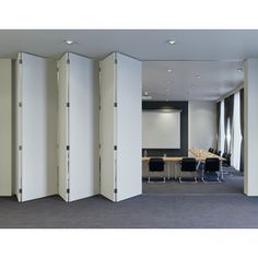 a room divider in an office setting with chairs and desks around the room