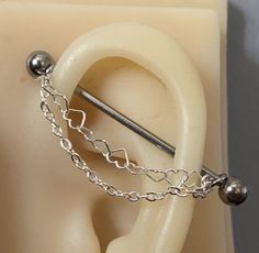 a close up of a pair of ear piercings